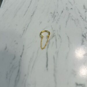 Gold vermeil ear cuff with dangle chain.